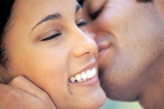 photo of student hugging and kissing another on the cheek