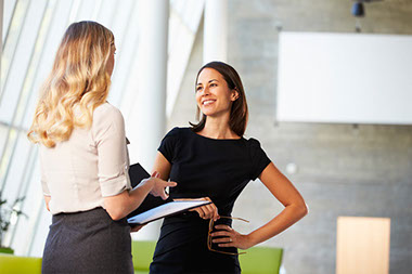 Image of two women talking.