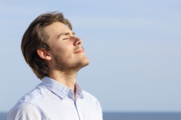 Image of man doing breathing exercises.