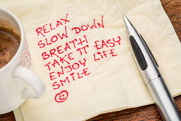 Image of words, 'Relax', 'Slow Down', 'Breath' written on a napkin.