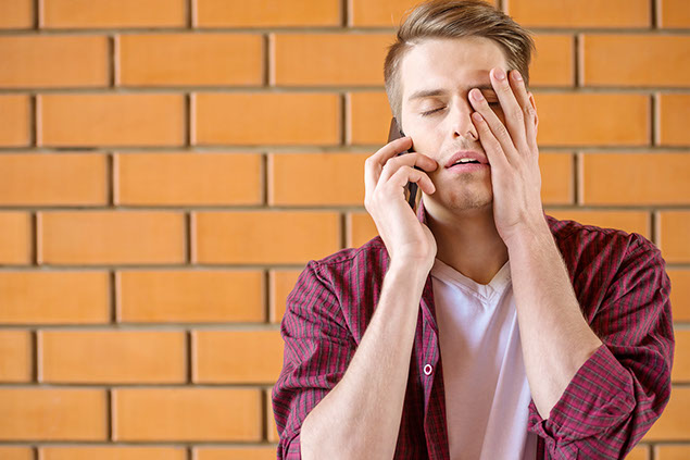 Image of annoyed man on the phone.