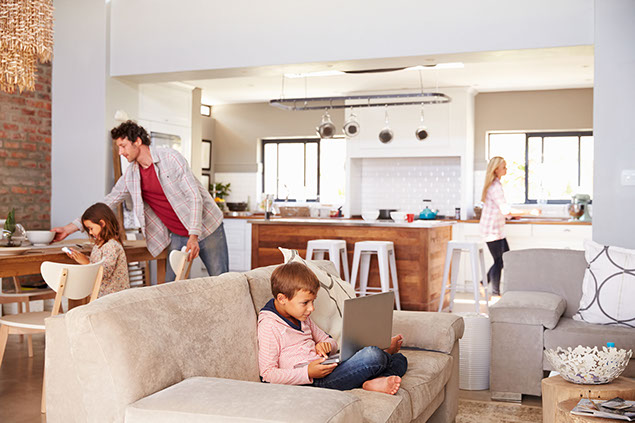 Image of family at home doing different tasks.
