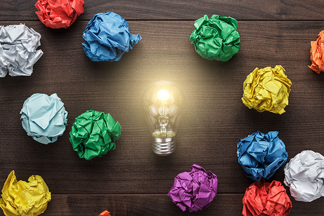 Image of crumpled colorful paper and light bulb.