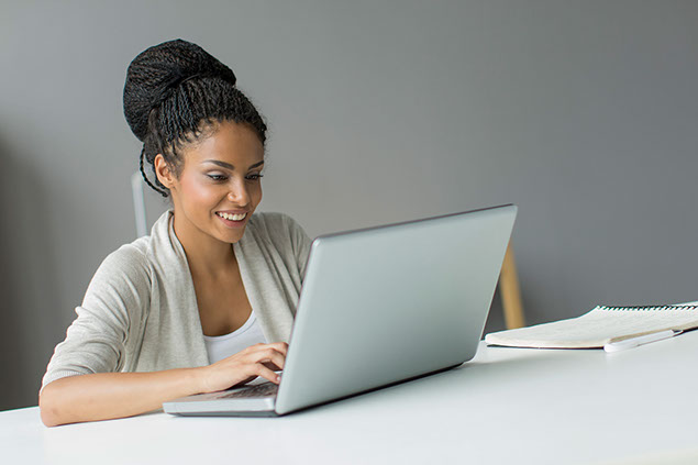 Image of smiling women on laptop.