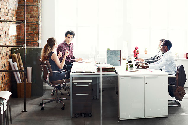 Image of open work area with coworkers.