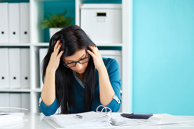 Image of stressed women at work.