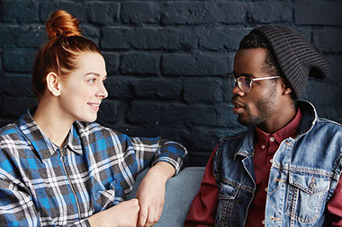 Image of friends sitting and talking to eachother.