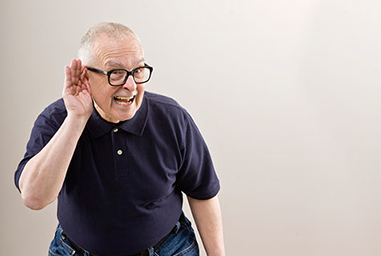 Image of mature man with hand up to his ear trying to hear.