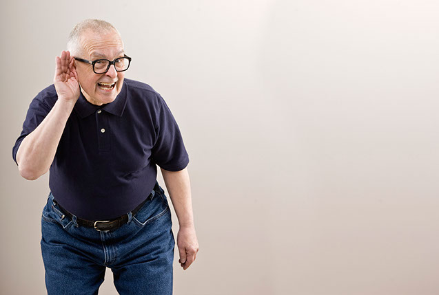 Image of mature man with hand up to his ear trying to hear.