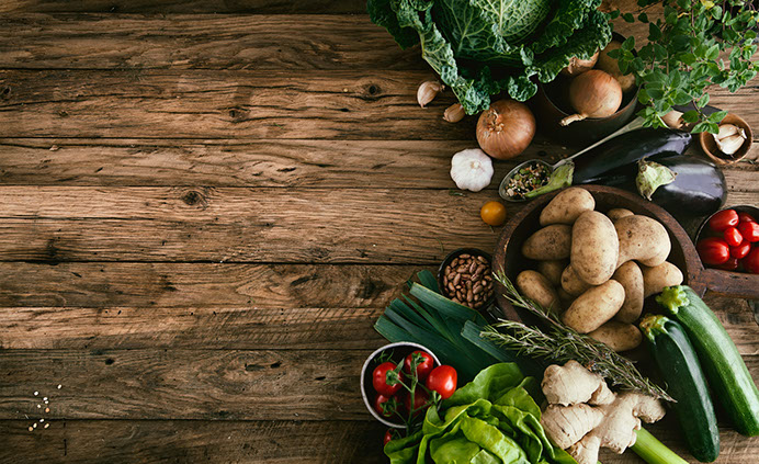 Image of fresh foods and herbs, such as potatos, tomatoes, onions, etc.