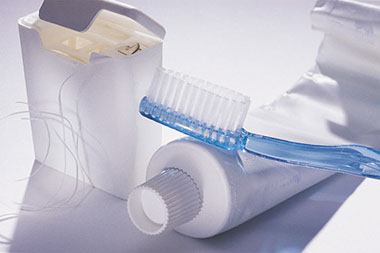 Image of toothbrush and toothpaste with floss.