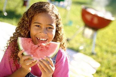 Image of young girl eating watermelon.