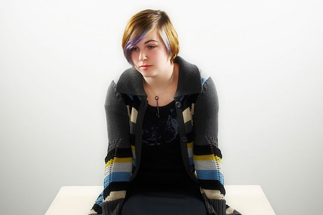 Image of teen sitting alone.