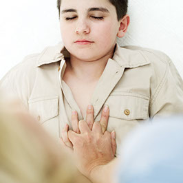 Image of child chest compressions.