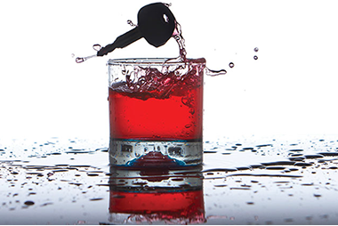 Image of an alcoholic drink with a car key.