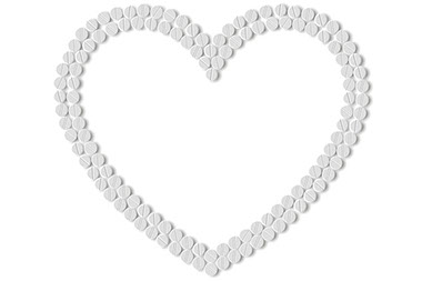 Image of aspirins shaped into a heart.