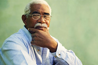 Image of elderly man with hand on chin.