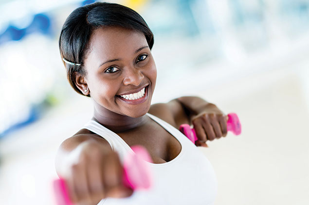 Image of young African American women with dumb bells.