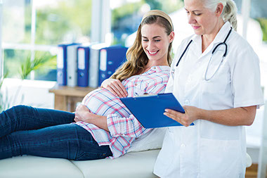 Image of pregnant women at the doctors office.
