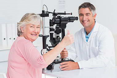Image of older women with thumbs up at an eye doctor appointment.
