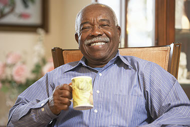 Image of elderly man drinking a cup of coffee.