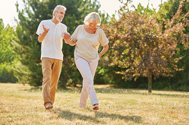 Image of an older couple walking outside.