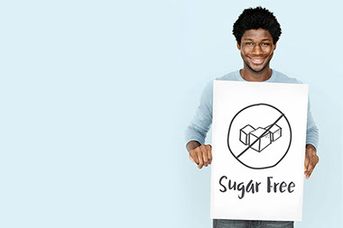 Image of man holding a sign that says 'sugar free.'