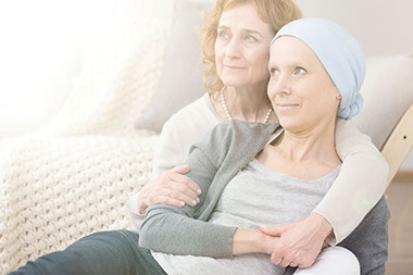 Image of women holding cancer patient.