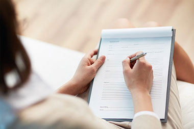 Image of person filling out forms.