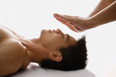 Image of person having healing touch therapy.