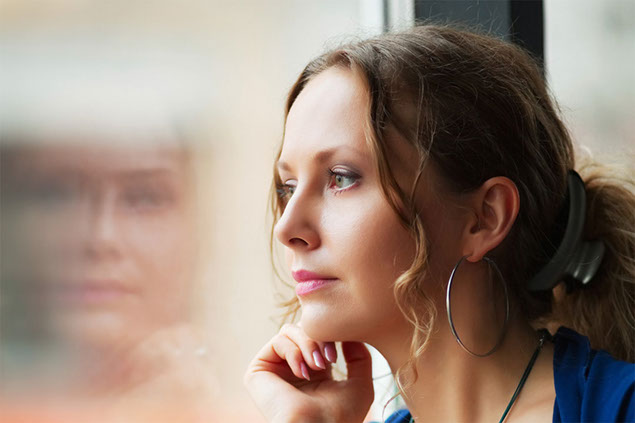 Image of women looking out window.