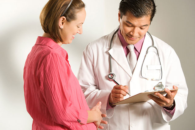 Image of pregnant women at a doctor's visit.