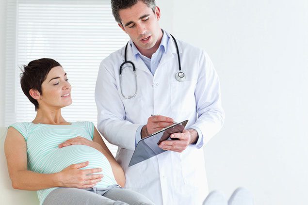 Image of pregnant women at a doctors visit.