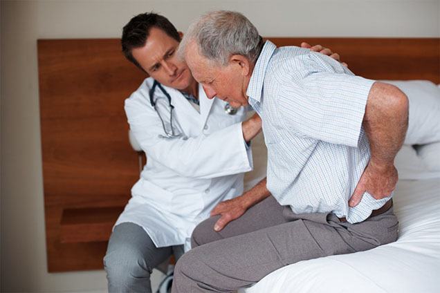 Image of doctor with patient suffering back pain.