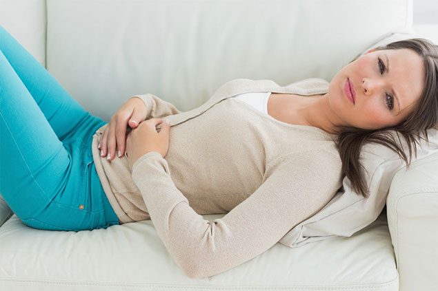 Image of women layingdown in pain.