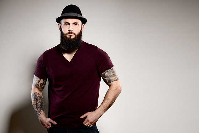 Image of man with tattoos on both arms.