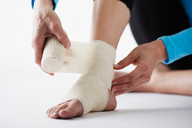 Image of person wrapping injuried ankle.