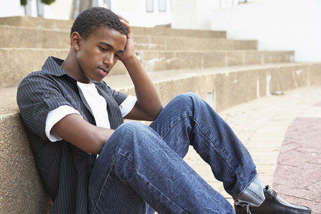Image of young boy sitting on stairs.