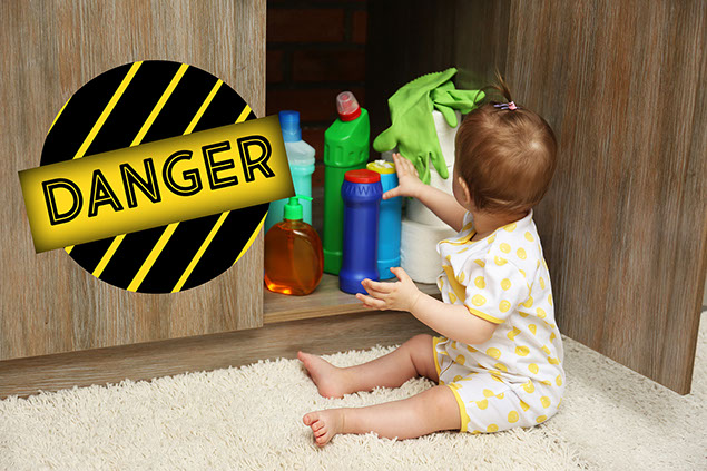 Image of baby playing with detergents in kitchen.