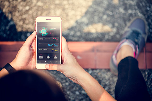 Person using digital device to track fitness and calories.