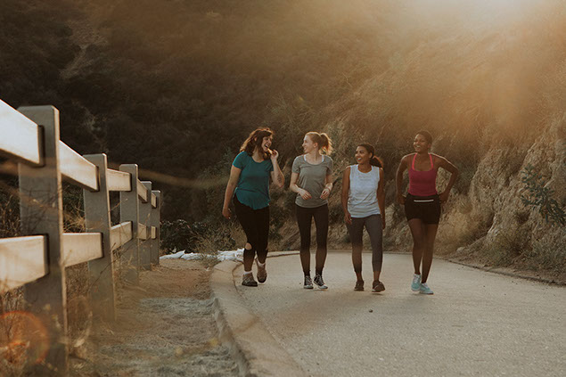 Friends hiking through hills.