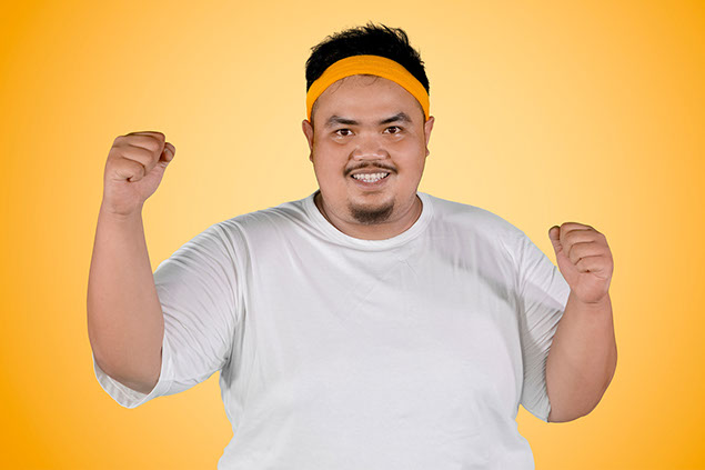 Man expressing his success to lose weight.