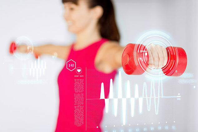 Woman hands with light red dumbbells.