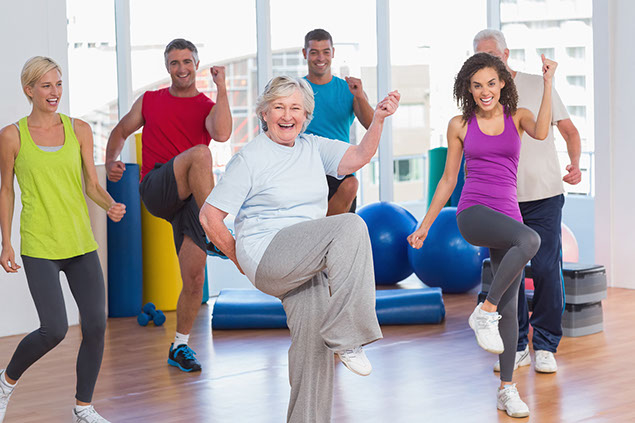 Group of people doing power exercise at fitness studio.