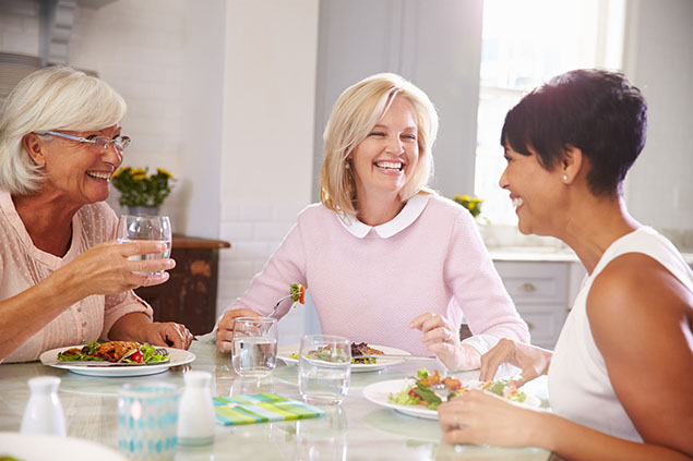 Group friends enjoying a meal at home.