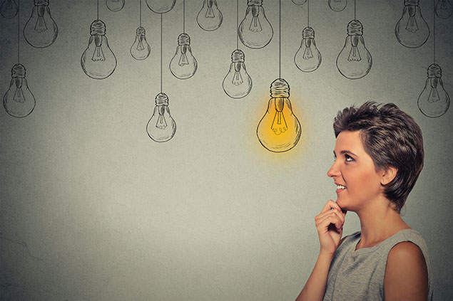 Concept of women thinking with drawing of lightbulbs.