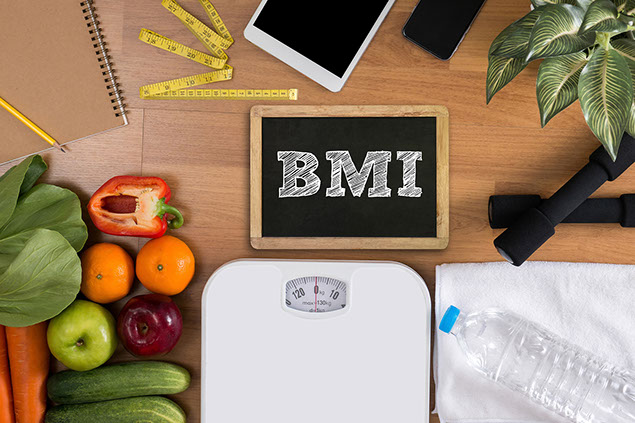 Dumbbells, scale, towel, fruit, BMI body mass index formula rate formula in a board.