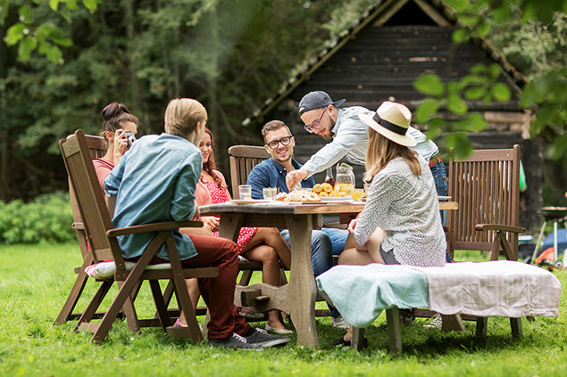Friends having dinner at summer garden party.