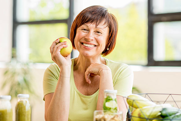 Smiling women with an apple.