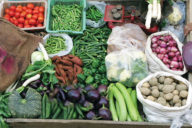 Image of a farmer's market stand filled with vegetables.